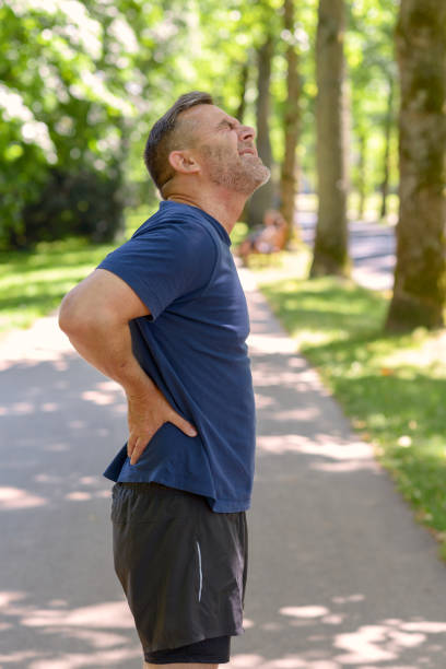 istock Mature man holding his painful back after running 986679068