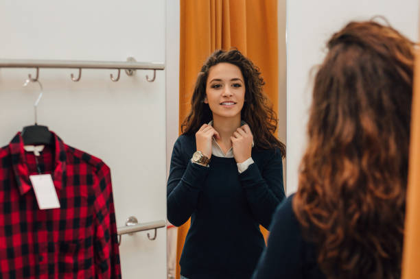 istock Woman trying clothes in dressing room. 986679090