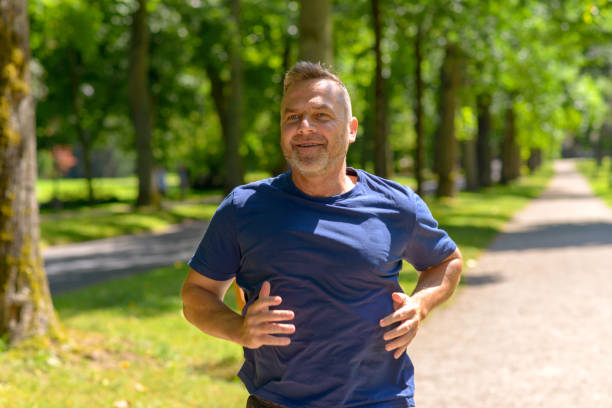istock Mature man running in park on sunny day 986679384