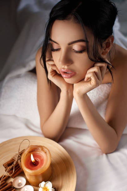 istock young woman in spa salon. 986679626