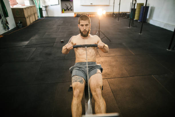 istock Man preparing for a rowing in the gym 986682108