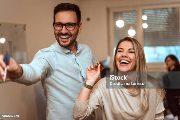 Image Of Business People Having Fun In Office Stock Photo - Download Image Now - Dart, Darts, Playing