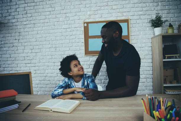 istock Black single father, along with son, do homework 986683106