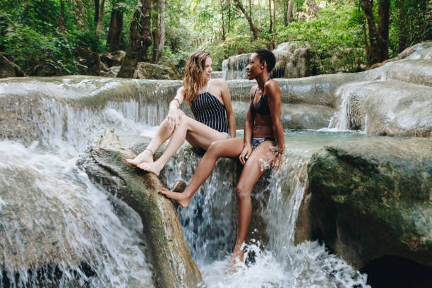 istock Women couple enjoying the waterfall 986683782