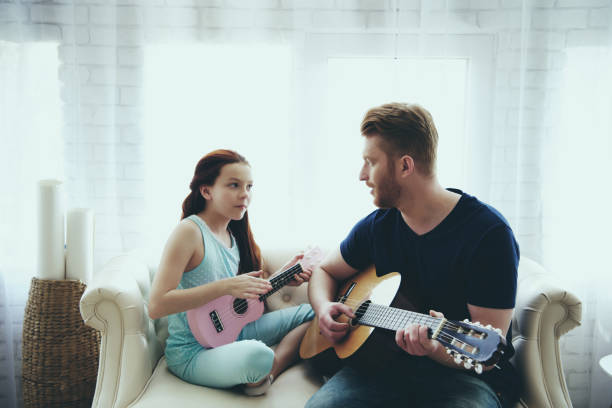 istock Enthusiastic single father and daughter plays 986687874