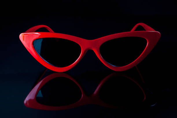 istock Red fashion sunglasses on a black background. 986690972