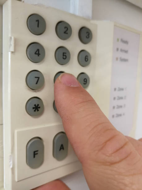 istock Male finger typing alarm password for unlock high security office 986691316