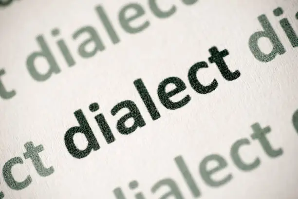 Photo of word dialect  printed on paper macro