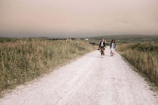 istock Two young women walking on a dirt road 986697802