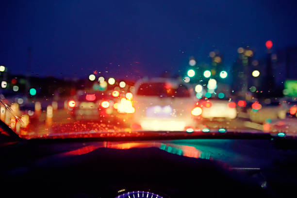 Blurred background : Inside car with bokeh lights from traffic jam on night time for background.