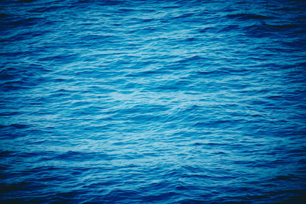 istock Sea water background. Blue ocean calm waves surface backdrop. 986698394