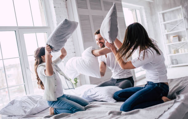 istock The happy family fighting with pillows 986705020