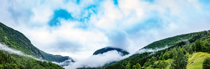 panoramic view of rocky mountains in the clouds; Norway