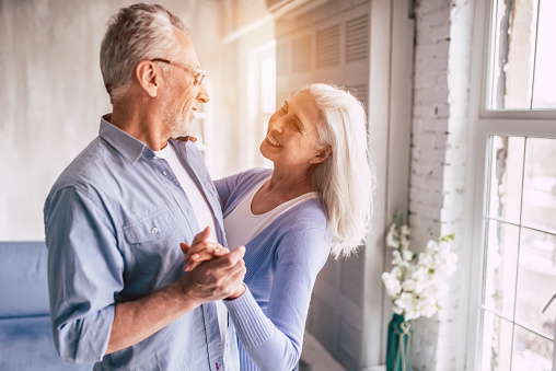 The smiling elderly woman and a man dancing