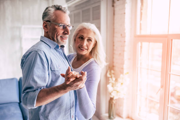 istock The happy elderly woman and a man dancing 986708926