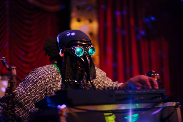 istock Man with mask playing music on stage 986709284