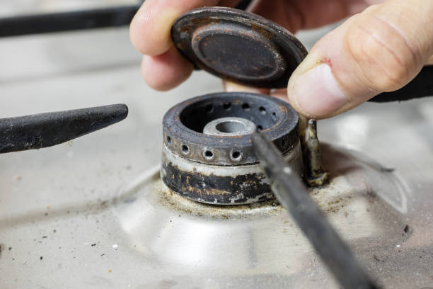 istock An old dirty gas kitchen. Device for preparing dishes in the kitchen. Dark background. 986709316
