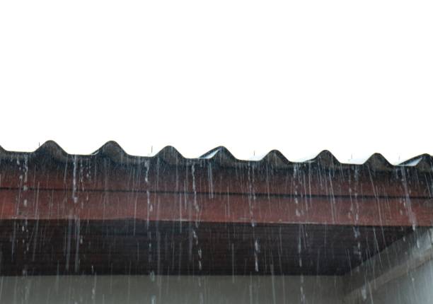 istock Rainwater flowing from the roof on white background 986711478