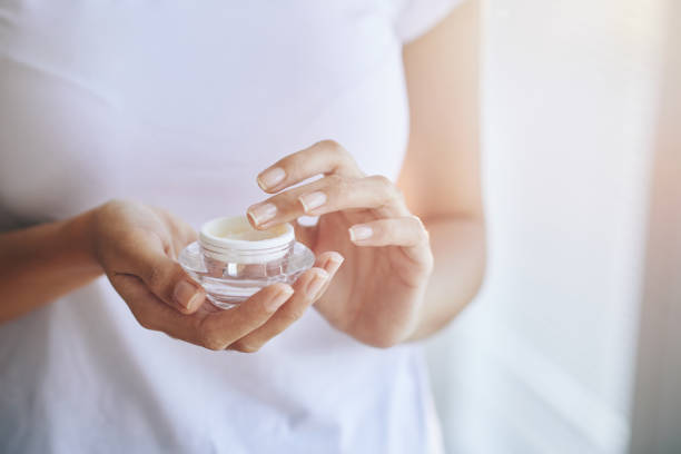 istock Crop woman holding?face cream 986711716
