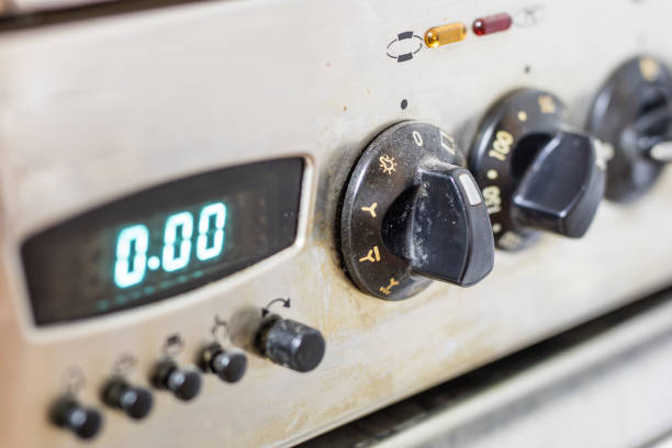 An old dirty gas kitchen. Device for preparing dishes in the kitchen. Dark background.