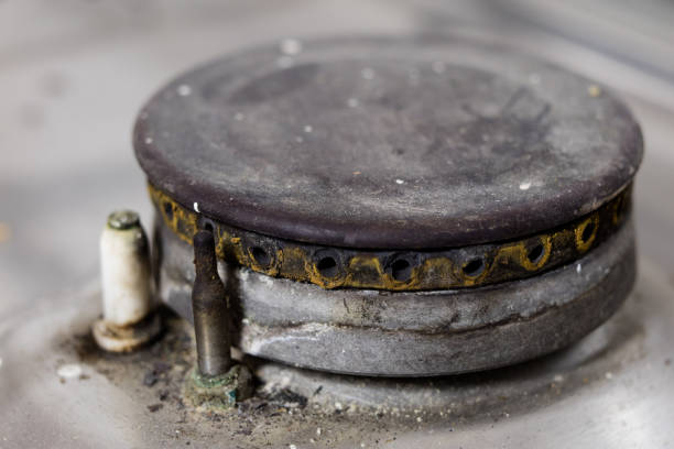 istock An old dirty gas kitchen. Device for preparing dishes in the kitchen. Dark background. 986717532