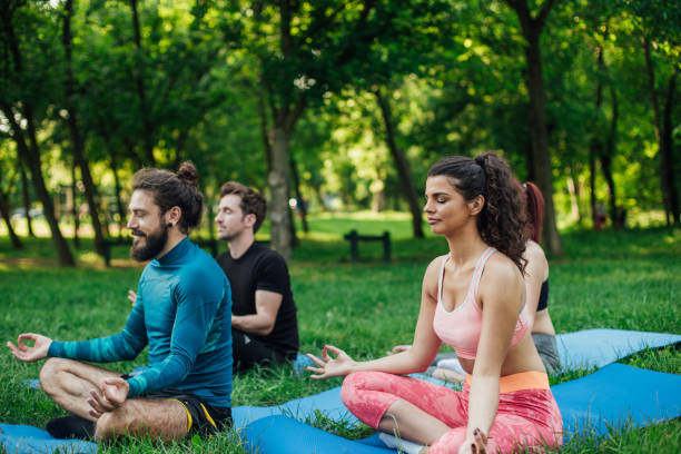 istock Group of young people doing yoga 986726492