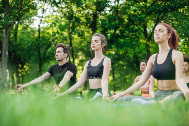 istock Small group of people exercising yoga 986727042