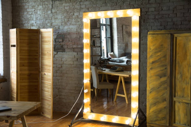 istock Large full-length mirror in a room with a brick wall and a window 986728052