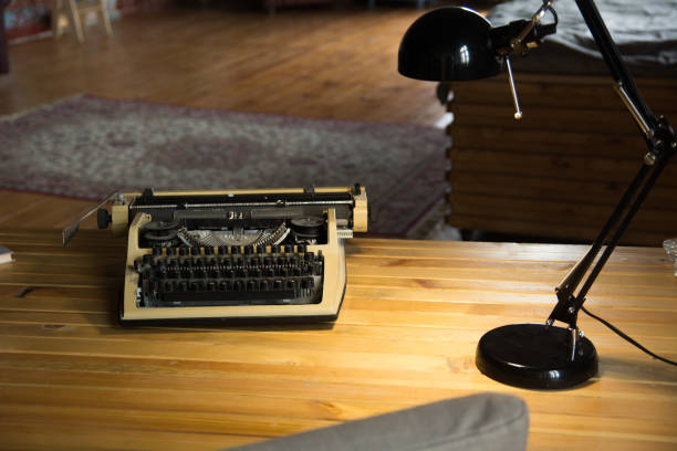 istock An old typewriter and a lamp on a wooden lacquered table and a room 986728058