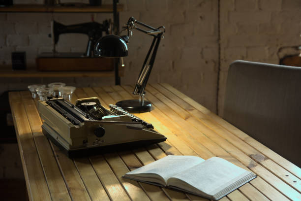 istock An old typewriter illuminated by a lamp on a wooden lacquered table 986728082
