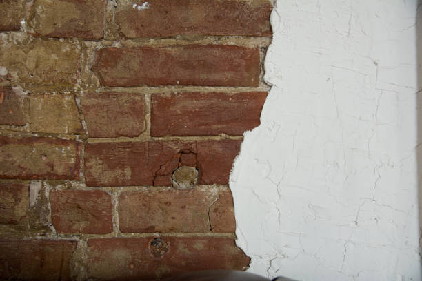 istock Background is an aged brick wall and white plaster 986728094