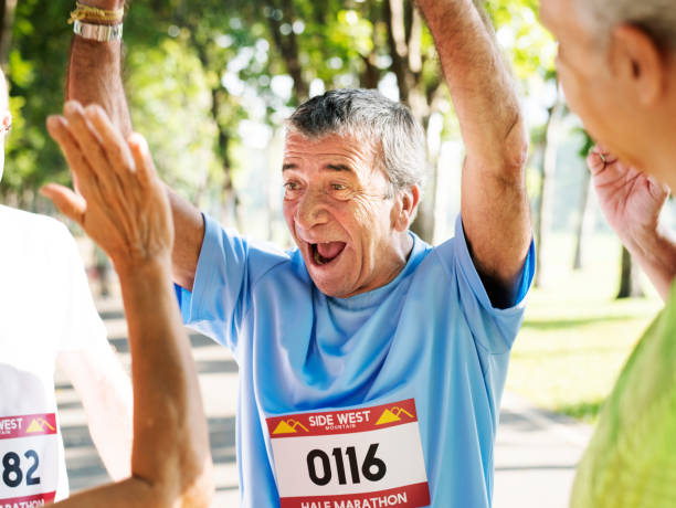 istock Group of cheerful senior runners at the park 986732472