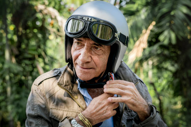 istock Mature man putting on a helmet 986732808