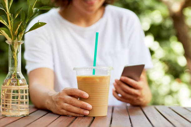 istock Woman Drinking Iced Coffee 986737266
