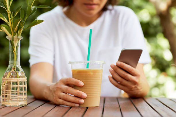 istock Woman Drinking Iced Coffee 986737304