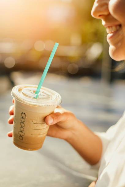 istock Woman Drinking Iced Coffee 986737488
