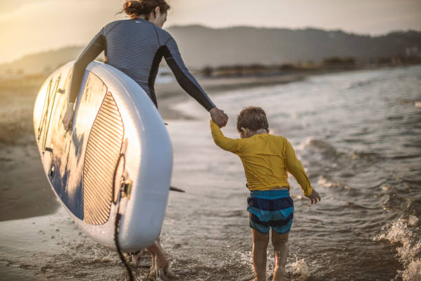 istock Family surfers at the beach 986741224