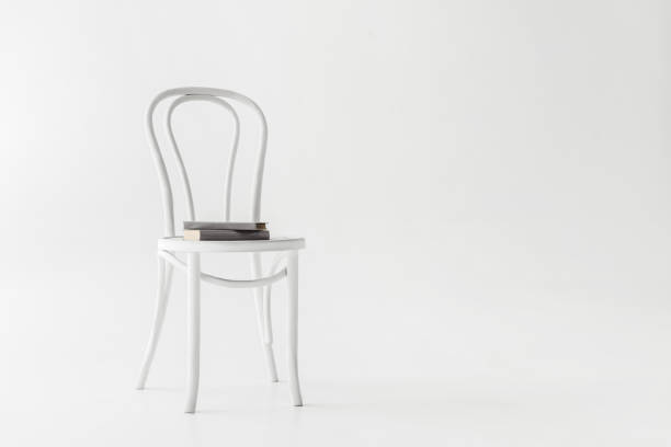 istock front view of chair with two books isolated on grey background 986745316