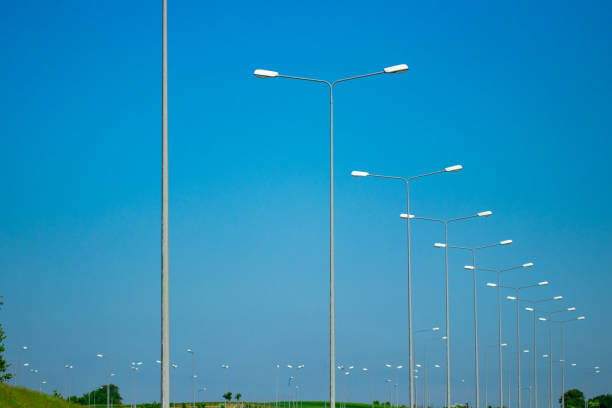 istock street lamps isolated with blue sky background 986747064