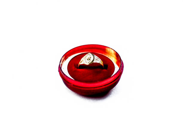 istock Gold ring in a red box isolated on white. 986747998