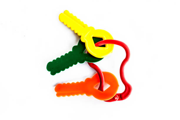 istock Bunch of different designed plastic keys of different color isolated on white. 986748540