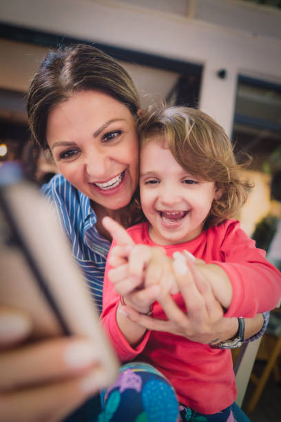 istock Mother and daughter in cafe 986754258