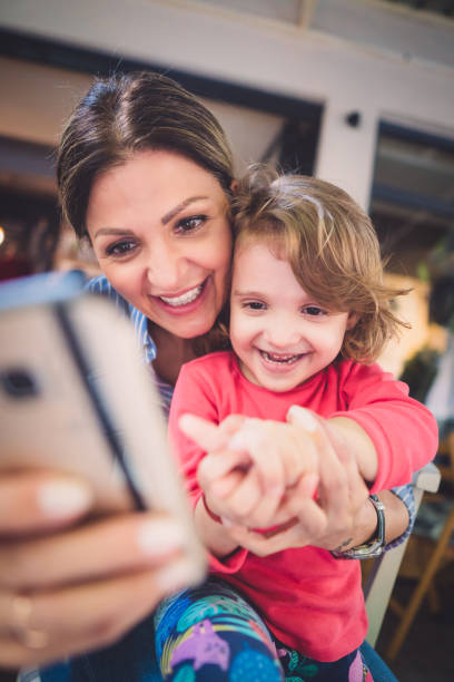 istock Mother and daughter in cafe 986754266