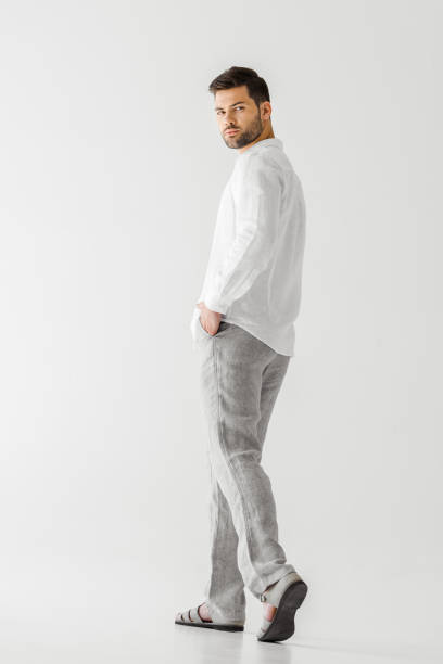 istock young handsome man in linen clothes posing isolated on grey background 986763276