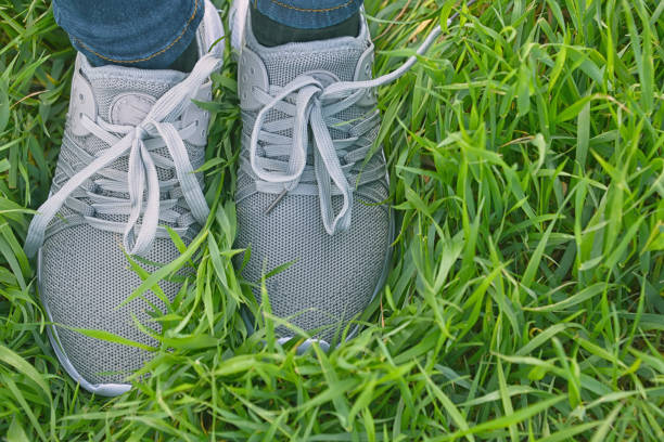 istock feet in boots on green grass 986797904