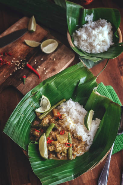 istock Indonesian Chicken Curry Dish with Rice Served on Banana Leaf 986797928