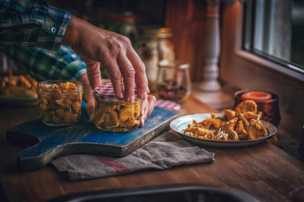 istock Preserving Organic Chanterelle Mushrooms in Jars 986797976