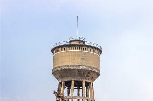 Horizontal close-up shot of old reinforced pale yellow colored concrete water tank in Izmir at Turkey in freetime of summer season