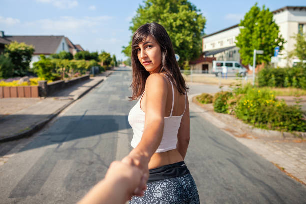 istock Young sexy girl holds a mans hand 986822444