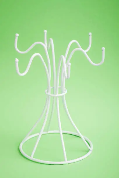 Empty white coffe mug  hanger on green background